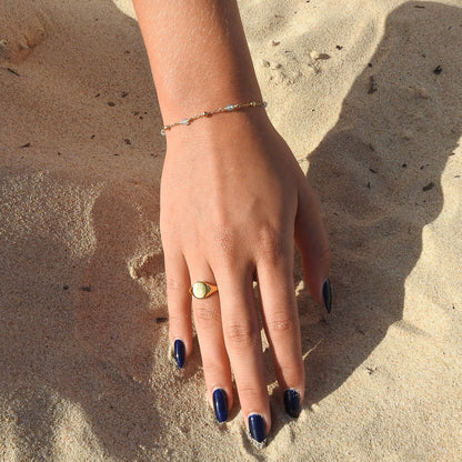March birthstone bracelet with interchanging gold pebbles and gemstones