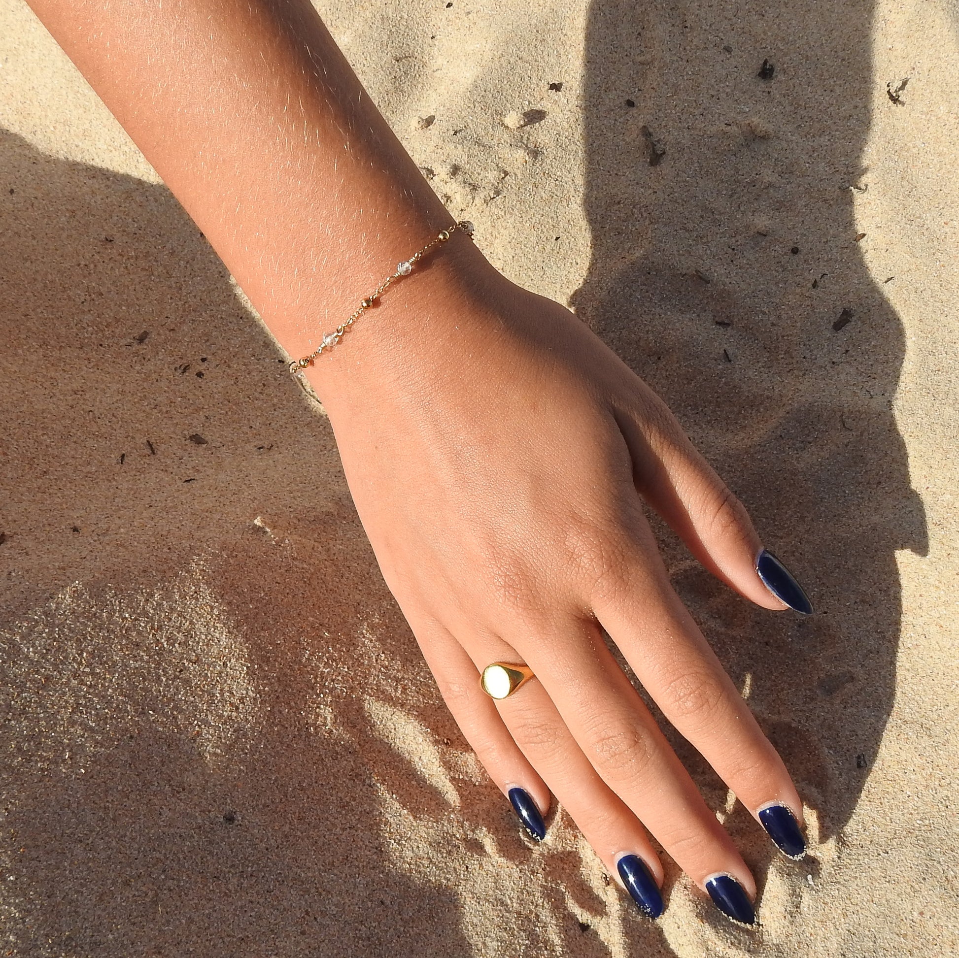 April birthstone bracelet with interchanging gold pebbles and gemstones